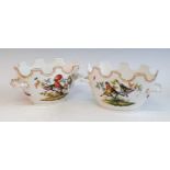 A pair of 19th century German porcelain bowls, each of oval form, having twin handles, enamel