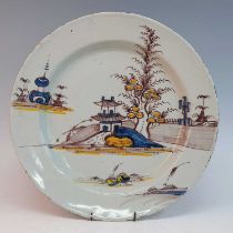 A circa 1760 Lancaster delftware charger, polychrome decorated with a pagoda within a landscape,