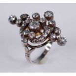 A white metal diamond openwork navette shaped cluster ring, comprising 30 Old European and rose