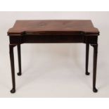 A George II mahogany card table, the foldover top with slightly dished corners for candles and