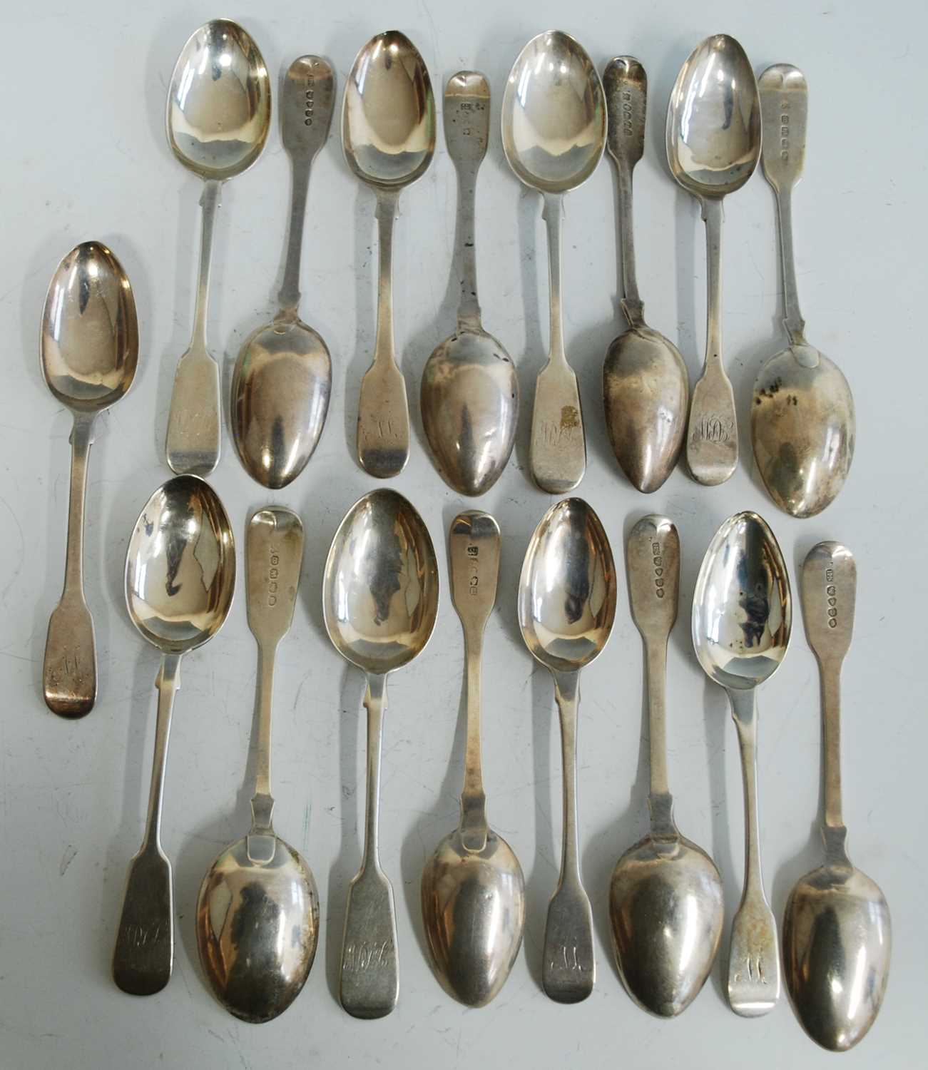 A collection of seventeen 19th century silver dessert spoons, all in the Fiddle pattern with