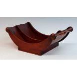 A George III mahogany cheese coaster, of typical curved form, having turned roundels to each end,