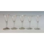 A matched set of five 18th century style wine glasses, the drawn trumpet bowl above a teared stem