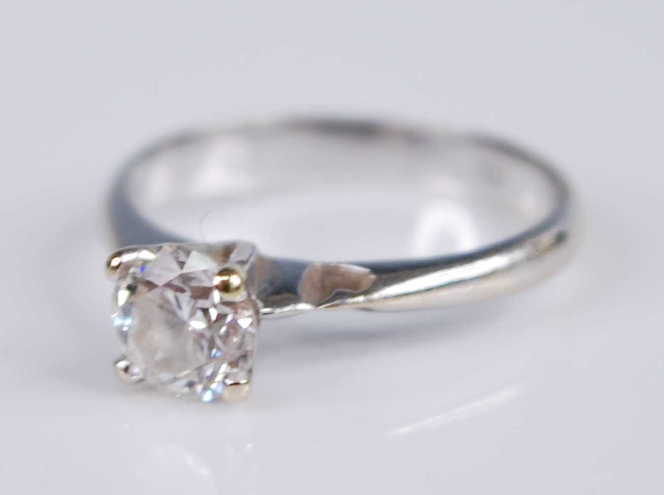 A white metal diamond solitaire ring, with a round brilliant cut diamond in a four-claw V shaped - Image 2 of 5