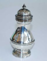 A George II silver pepperette, of belted bellied baluster form to the reeded stepped circular