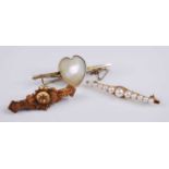 Three yellow metal brooches, comprising a graduated cultured pearl bar brooch having eleven pearls