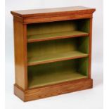A Victorian style walnut and figured walnut open bookcase, having a cross and feather banded top