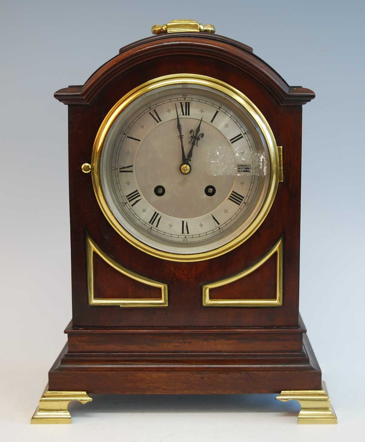 An early 20th century mahogany and brass mounted bracket clock in the Georgian style, having an