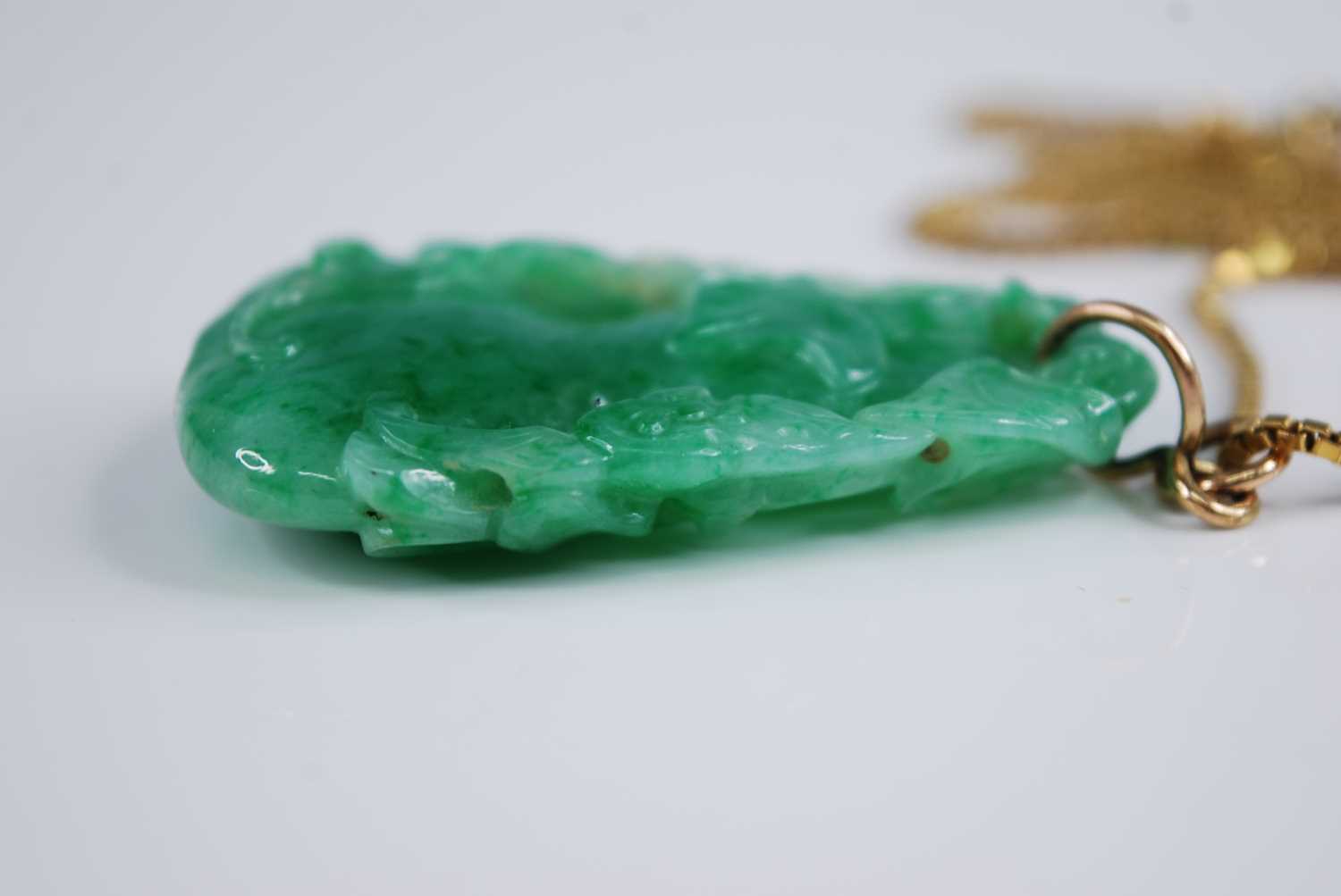 A Chinese carved green and celadon jade pendant, modelled as a gourd issuing leaves and foliage, h. - Image 4 of 7