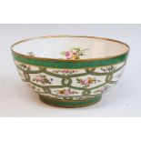 A Victorian Rockingham bowl, enamel decorated with floral sprays upon an apple green ground, printed