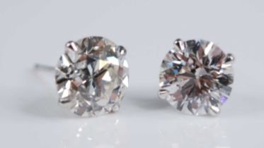 A pair of Edwardian platinum diamond set ear studs, each being Old European cut stones, in four-claw