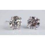 A pair of Edwardian platinum diamond set ear studs, each being Old European cut stones, in four-claw