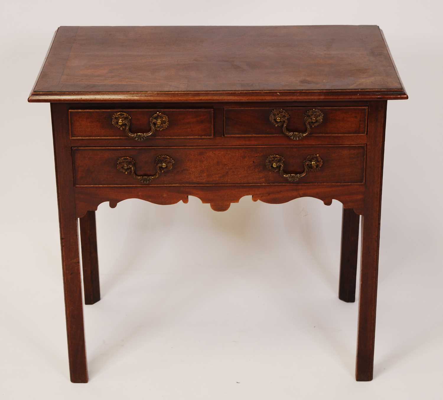 A George III mahogany and crossbanded lowboy, having configuration of two short over single long