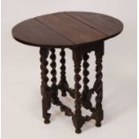 An 18th century provincial joined oak dropleaf occasional table, the oval fall leaves with gateleg
