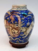 A 19th century Persian Qajar earthenware vase, decorated with fighting animals upon a cobalt ground,