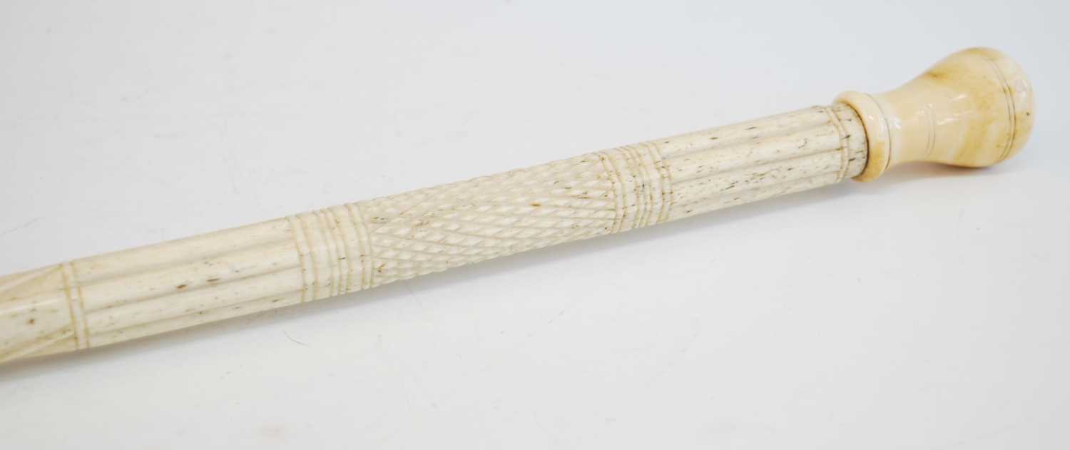 A 19th century narwhal tusk carved walking stick, the shaft carved with reeded top section and