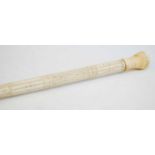 A 19th century narwhal tusk carved walking stick, the shaft carved with reeded top section and