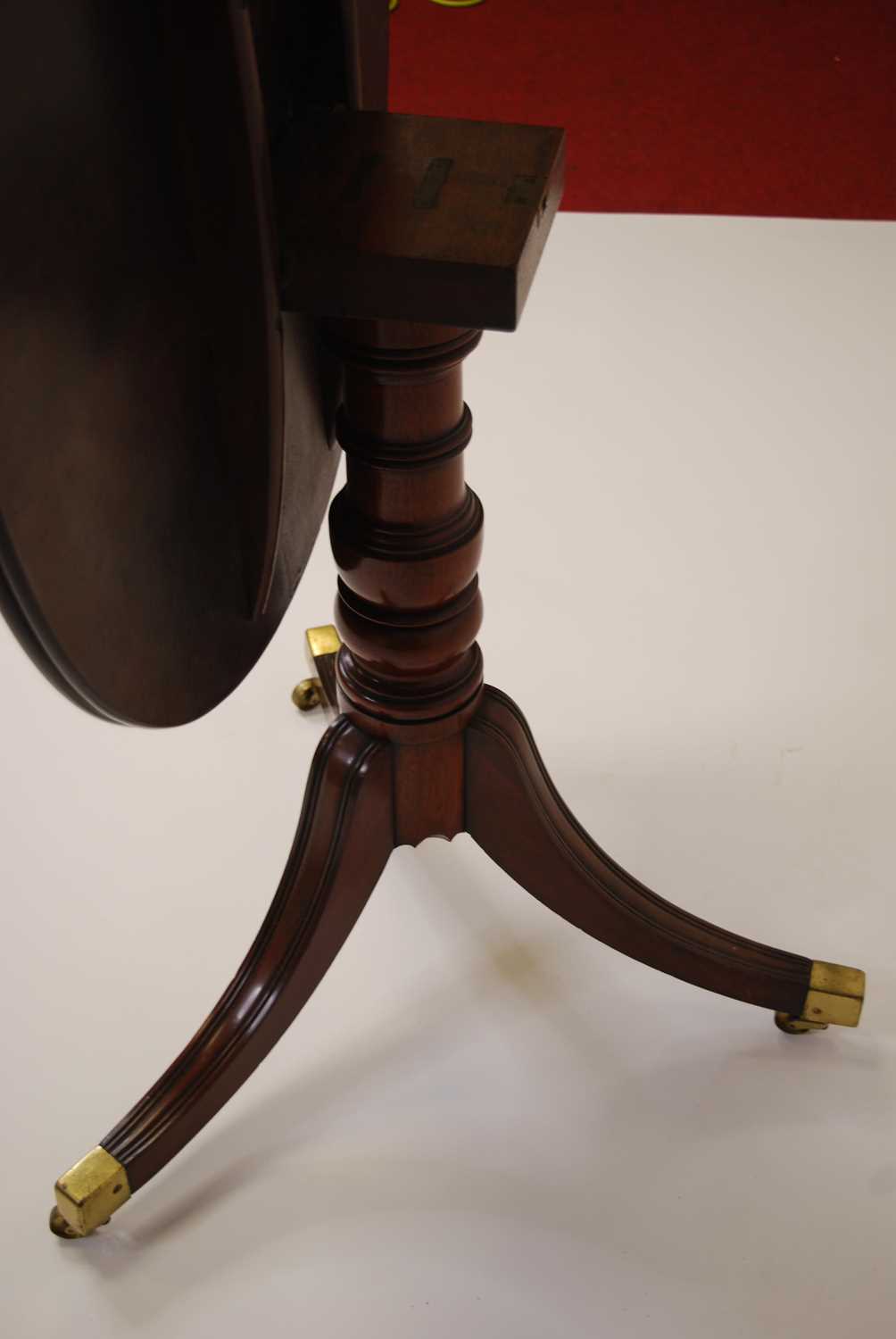 A Regency plum pudding mahogany circular tilt-top pedestal tripod table, raised on ring turned - Image 2 of 4