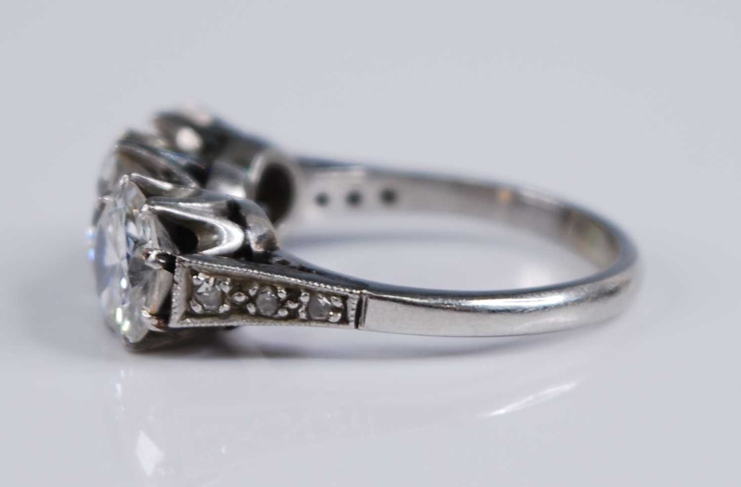 A white metal diamond three stone ring, comprising three round brilliant cut diamonds in claw - Image 4 of 7