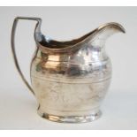 A George III cream jug, of helmet form with reeded angular handle, having banded foliate