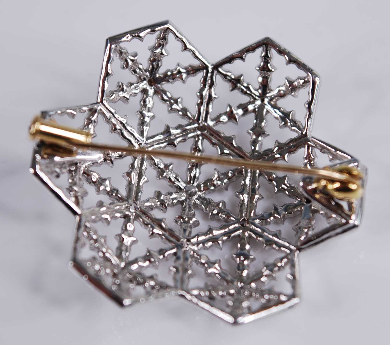 A modern 18ct white gold and diamond set snowflake brooch, of openwork convex form, centre set - Image 2 of 3