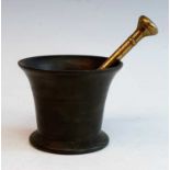 An 18th century bronze mortar, of plain tapering form, h.10.5cm, together with a bronze pestle