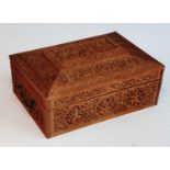 A 19th century Anglo-Indian sandalwood box, profusely carved with figures amongst foliage, the lid