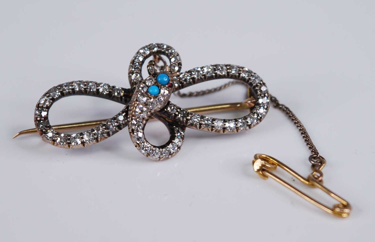 An Edwardian yellow metal diamond set snake brooch, comprising 63 graduated round cut diamonds, - Image 2 of 4