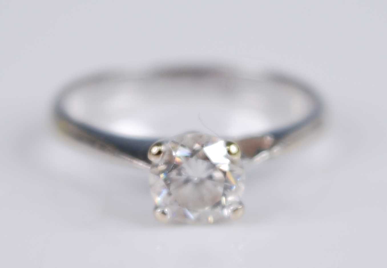 A white metal diamond solitaire ring, with a round brilliant cut diamond in a four-claw V shaped - Image 3 of 5