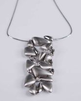 A Miluna of Italy contemporary 18ct white gold and diamond set pendant, the abstract design of