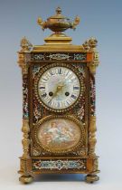 An early 20th century French ormolu and champleve enamel mantel clock, the convex white enamel Roman