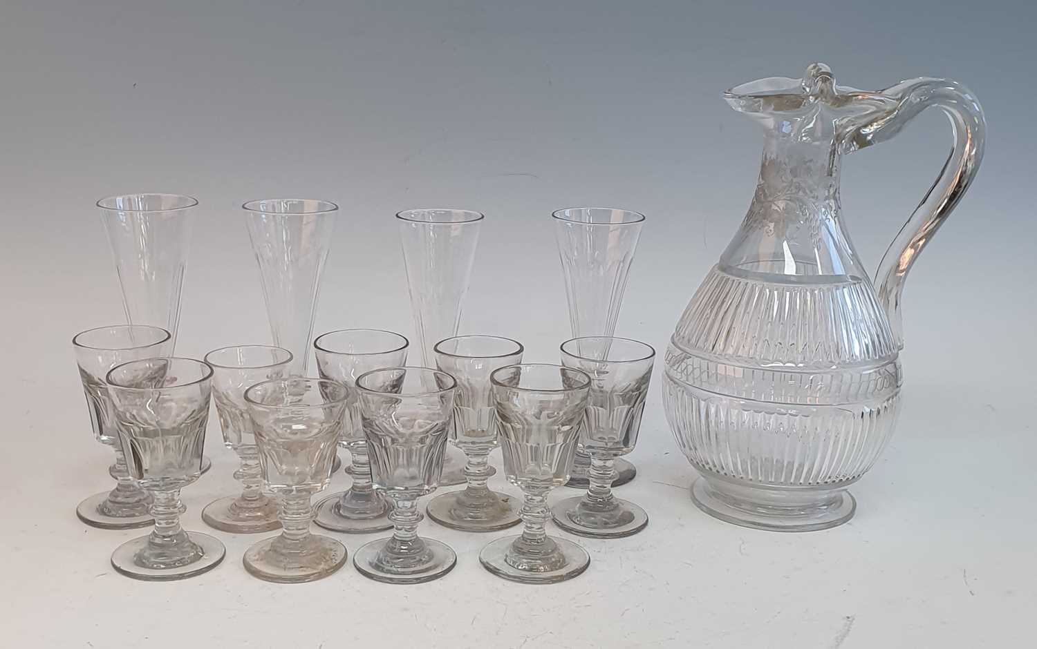 A Regency glass claret jug, wheel engraved with trailing vines, h.28cm, together with a set of