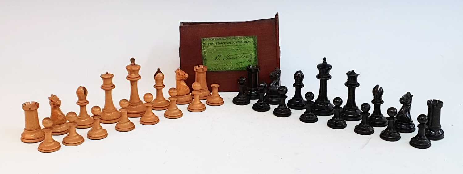 A late 19th century Jacques Staunton boxwood and ebony chess set, the rooks and knights bearing a