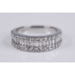 A contemporary platinum and diamond set half hoop ring by Pravens, the tapering band centre set with
