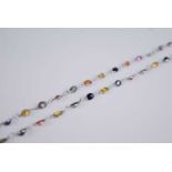 A contemporary white metal multi-sapphire necklace, the 42 bezel set oval cut sapphires in a wide