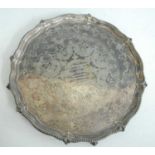 A Victorian silver presentation salver, of shaped circular form standing upon four claw and ball