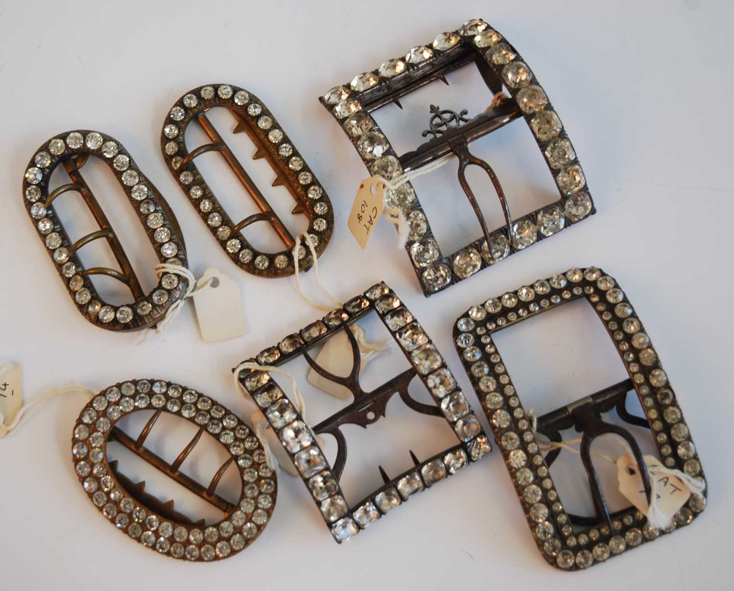 A collection of six Georgian and Victorian steel and paste set single shoe buckles, of rectangular