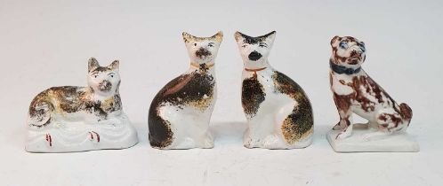 A pair of circa 1850 Staffordshire cats, each in seated pose, sponge decorated in ochre and brown,