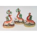 A collection of three circa 1860 Staffordshire models of giraffes, each shown resting beneath a palm