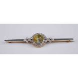 A yellow and white metal, cymophane and diamond bar brooch, the round cabochon cut cymophane