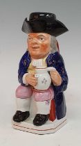 An early 19th century Staffordshire Enoch Wood type 'ordinary' Toby jug, shown holding a foaming