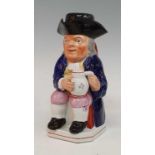 An early 19th century Staffordshire Enoch Wood type 'ordinary' Toby jug, shown holding a foaming