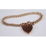 A 9ct gold curblink bracelet, having engraved heart shaped padlock clasp with safety chain, 22.2g,
