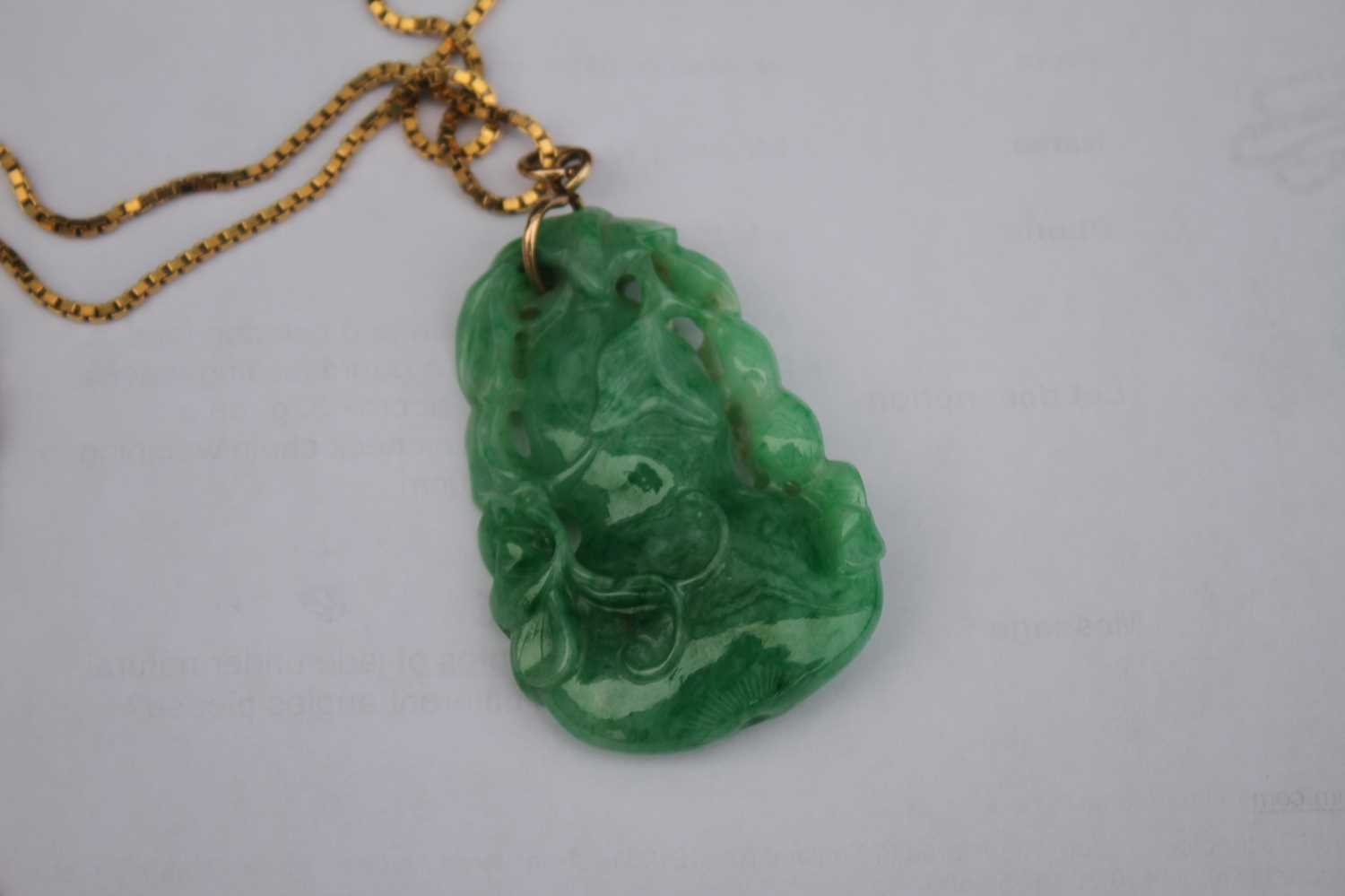 A Chinese carved green and celadon jade pendant, modelled as a gourd issuing leaves and foliage, h. - Image 6 of 7