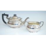 A mid-20th century silver teapot and sugar duo, each piece of oval bombe form to a stepped foot