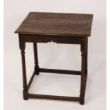 An 18th century provincial joined oak side table, having a two-plank top, raised on turned and