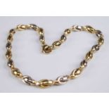 A 9ct yellow and white gold fancy interlocking stirrup link necklet, with rounded trigger clasp,