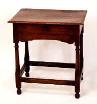 An 18th century provincial joined oak single drawer side table, raised on turned and square cut