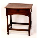 An 18th century provincial joined oak single drawer side table, raised on turned and square cut