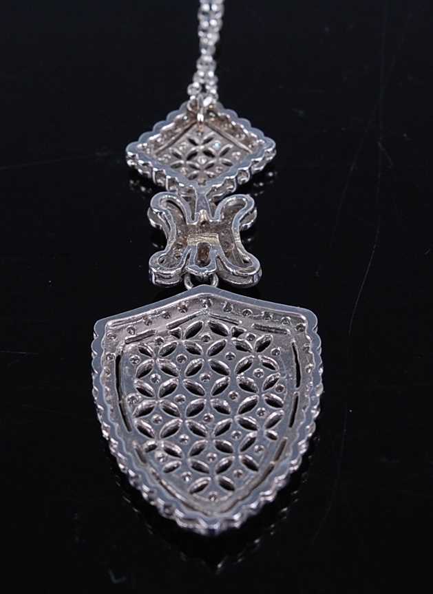 A white metal diamond articulated shield shaped pendant, having 106 melee cut diamonds grain set - Image 2 of 3